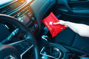 Person taking first aid bag out of glove box
