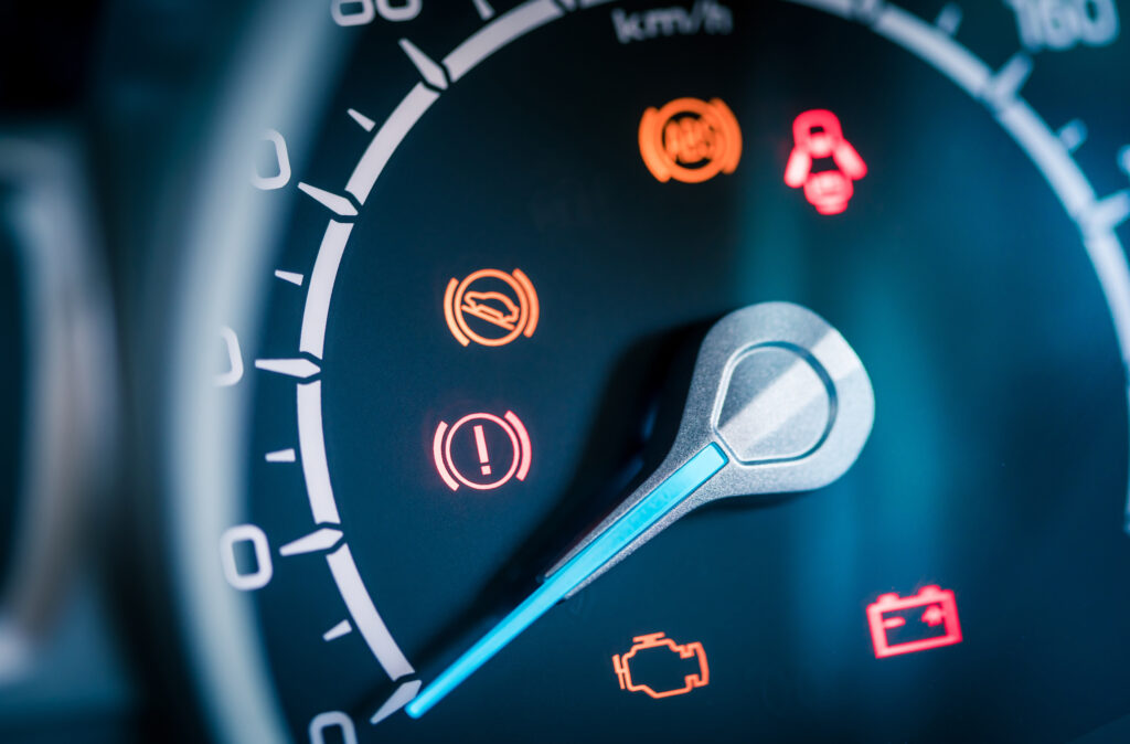 Many different car dashboard lights with warning lamps illuminated.