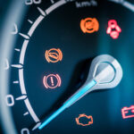 Many different car dashboard lights with warning lamps illuminated.